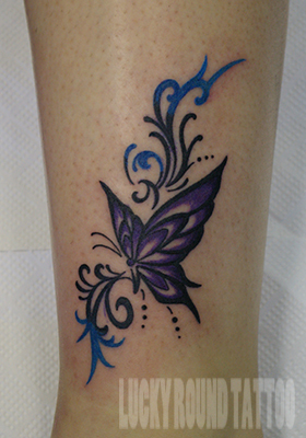 紫色の蝶とトライバル飾りのタトゥー Lucky Round Tattoo